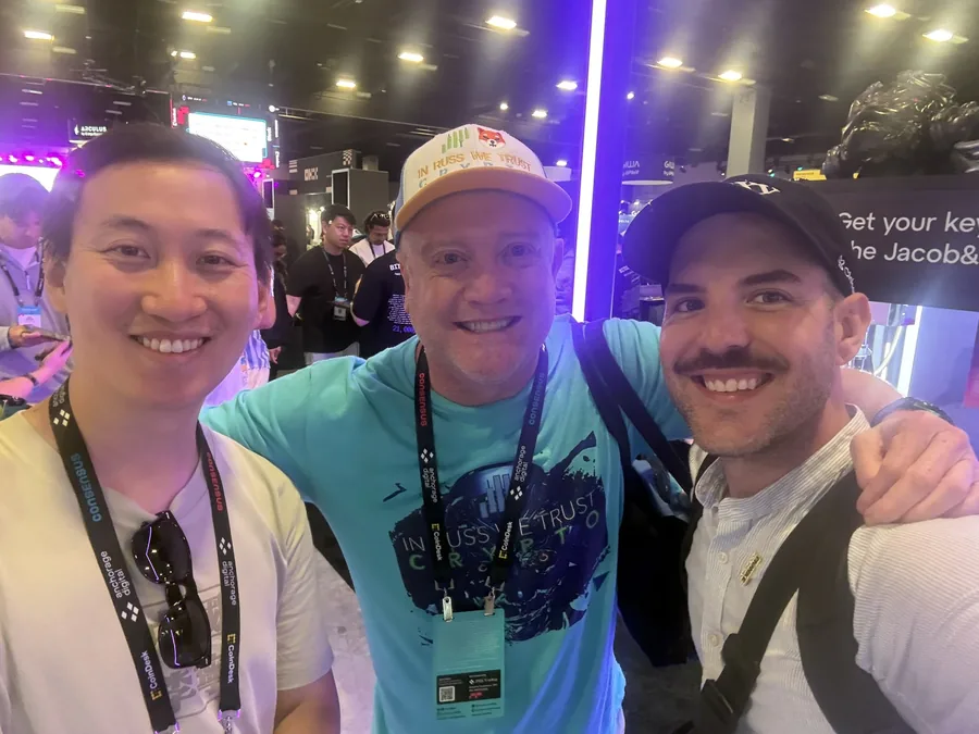 Matthew with two friends at Consensus 2026.