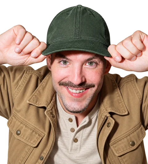 Matthew Karsten in a forest-green cap, holding the brim.