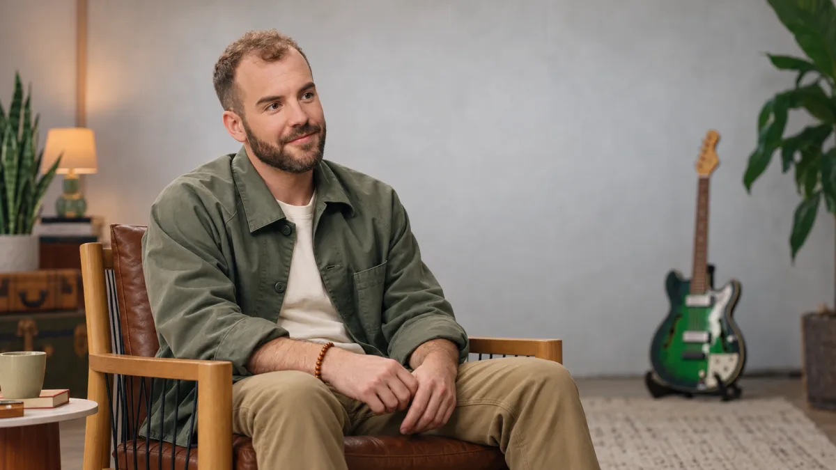 Matthew Karsten seated and turned toward the camera, thoughtful expression.